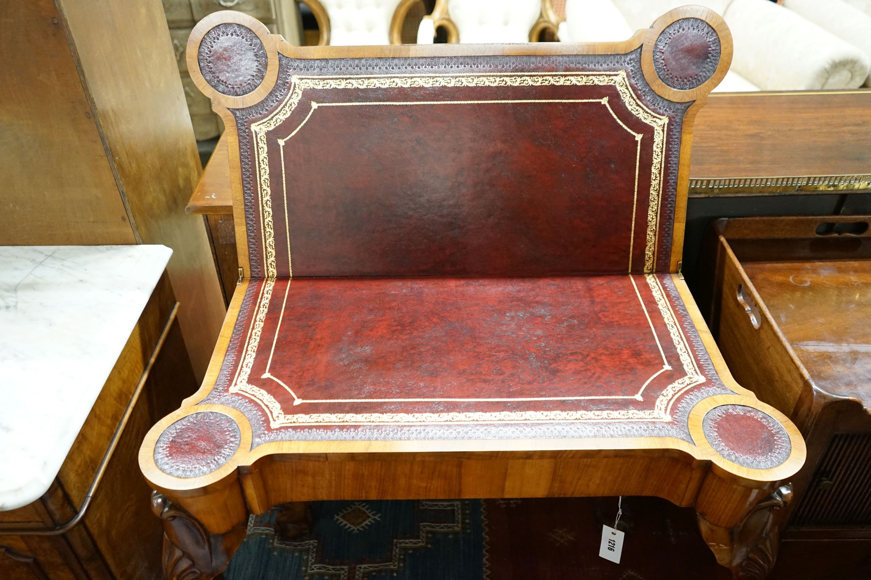 A Queen Anne revival burr walnut card table, with a red leather interior, length 86cm, depth 43cm, height 74cm